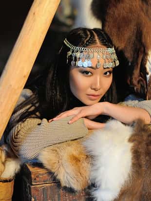 Winter wedding portrait of a beautiful Asian bride.