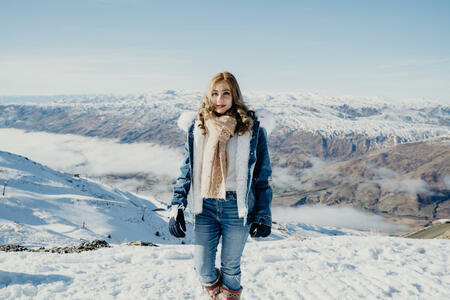 Beautiful asian woman enjoy view with snow during winter in New Zealand.