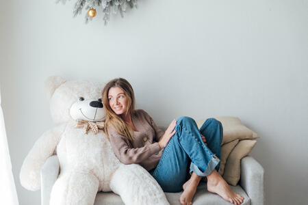 woman with a white teddy bear for Christmas