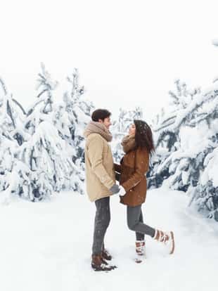 Christmas Mood. Loving Couple Holding Hands Standing In Beautiful Winter Forest. Panorama, Free Space