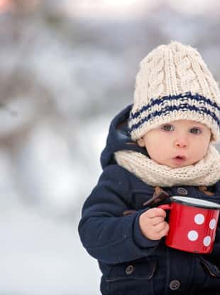Sweet siblings, children having winter party in snowy forest. Kids friends rest outdoor at nature. Young brothers, boys, drinking tea from thermos. Hot drinks and beverage in cold weather