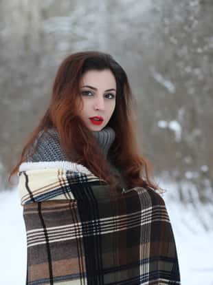 Beautiful girl in a beautiful winter park for a walk