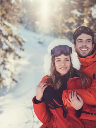 Smiling couple spending time together at ski holiday
