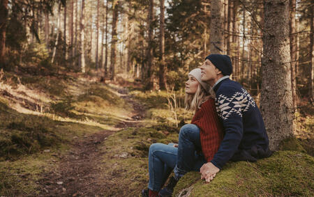 Couple out in the forest enjoying nature togetherMarried couple relaxing in the woods adventure in nature