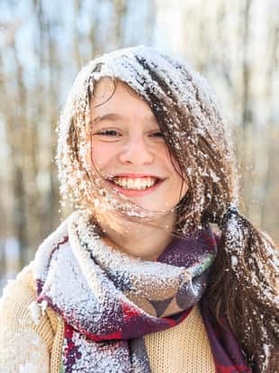 funny teenager girl portrait with the snow on the hair. Winter, outdoor, daylight.