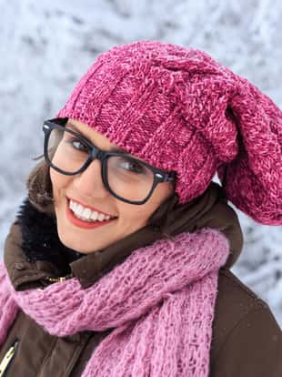 Young woman with warm clothes having fun in snow mountain.