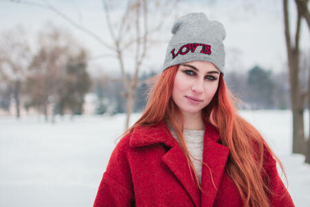 Portrait of young woman in winter park.