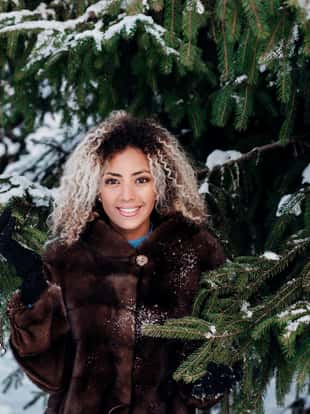 Winter portrait of a young smiling african american woman outdoor in winter day