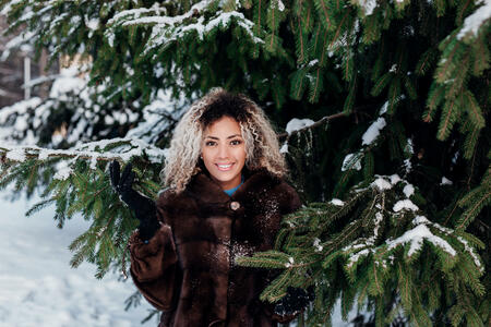 Winter portrait of a young smiling african american woman outdoor in winter day