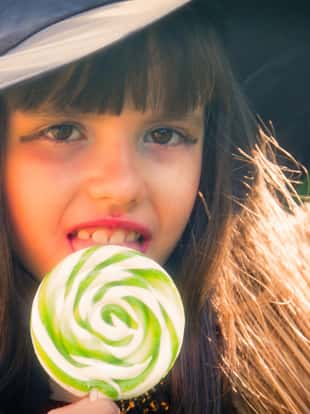 witch eating a candy lollipop, halloween party