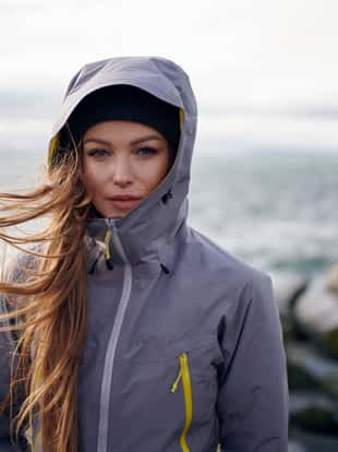 Shoot of young beautiful woman wearing rain jacket in cold weather