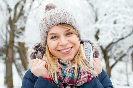 Picture of a young woman being cold outside on wintertime