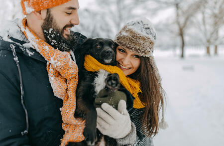 Happy young couple having fun in snow