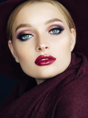 Beautiful girl with make-up and purple hat