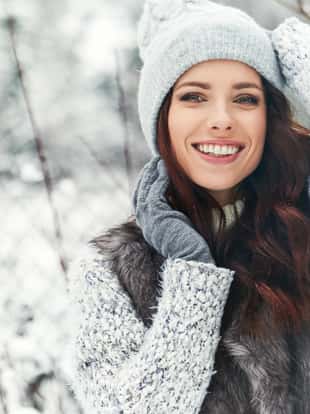 beautiful smiling young woman in wintertime outdoor. Winter concept
