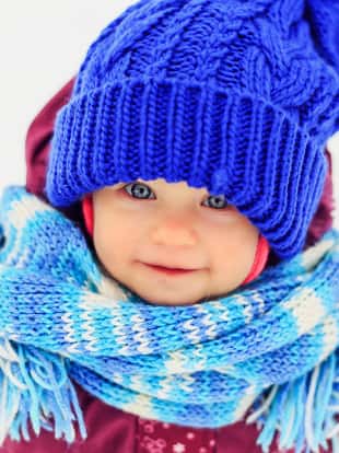 Funny little girl in winter park. Winter fun, happy childhood.