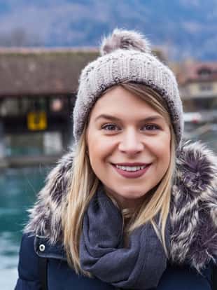 Portrait of an attractive young woman smiling at the camera in Interlaken, Switzerland, swiss alps