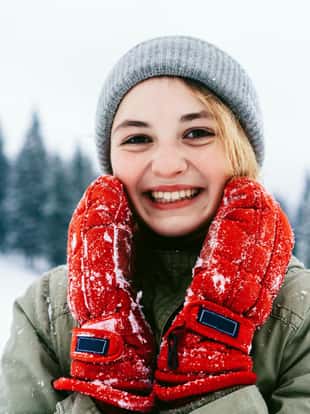 Woman in red gloves smiling