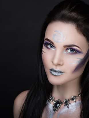 Creative make-up new conceptual idea. Purple silver bold faceart body art painting. Crazy new graphic abstract picture woman face surrealistic. professional photo. Creativity lines conceptual winter