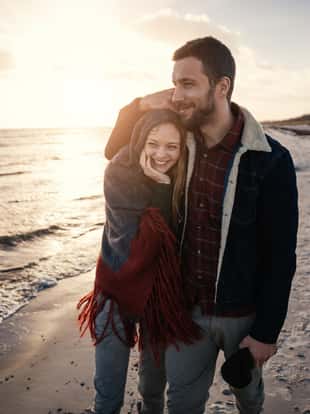 Photo of a lovely couple walking on the beach