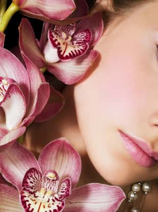Portrait of woman with pink orchids