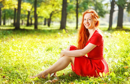 Happy redhead young woman outdoor in summer