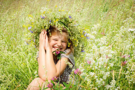 Happy smiling dlevushka Meadow. A large floral wreath on her head