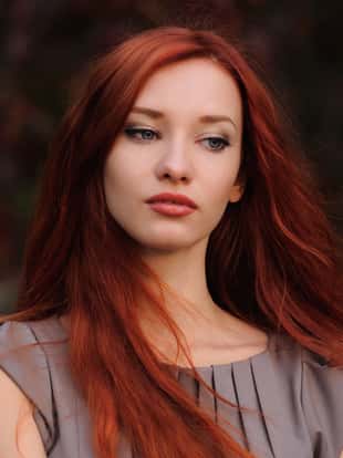 Outdoors portrait of beautiful young woman with red hair colorful autumn