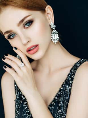Portrait of a nice looking woman with beautiful ring and earings. Professional make-up