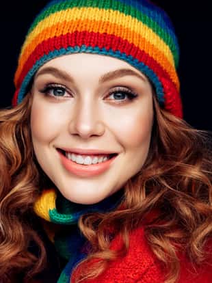 Portrait of beautiful woman in multicolor winter hat
