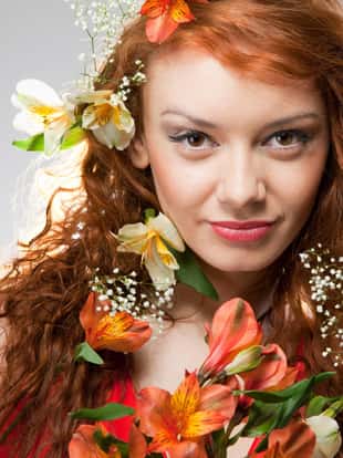 Portrait of beautiful woman with spring flowers