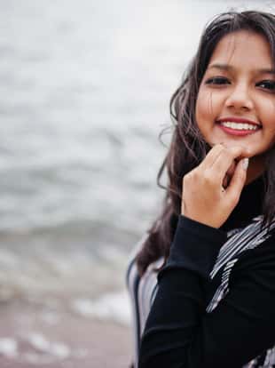 Close up portrait of young beautiful indian or south asian teenage girl in dress.