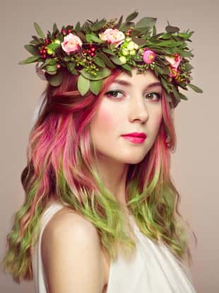 Beauty fashion model girl with colorful dyed hair. Girl with perfect makeup and hairstyle. Model with perfect healthy dyed hair. Flower wreath on head