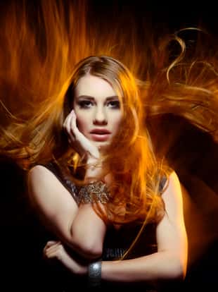 attractive woman with portrait in fire , flying hair.