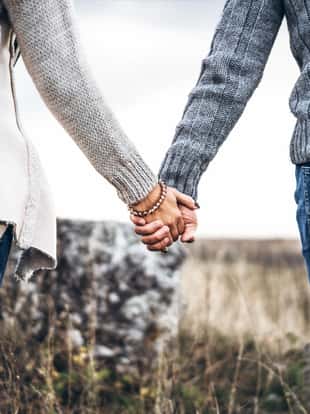 Photo of romatic couple hands, walking outdoor and spending time together