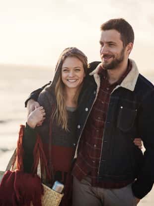 Photo of a lovely couple walking on the beach