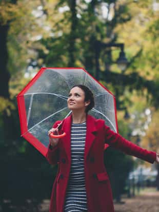 Beautiful young woman enjoying a rainy day