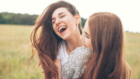 Two young women having fun. Close up.