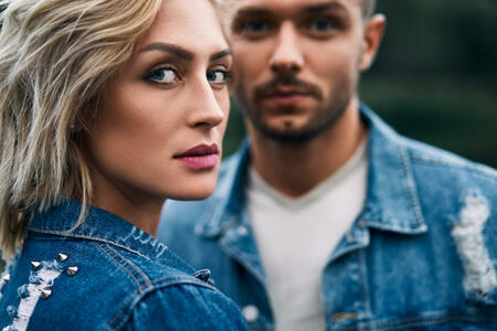 Closeup portrait of beautiful couple wear denim jeans. Fashion people, love, romance concept