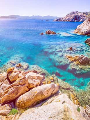 Pure clear azure sea water and amazing rocks on coast of Maddalena island, Sardinia, Italy.