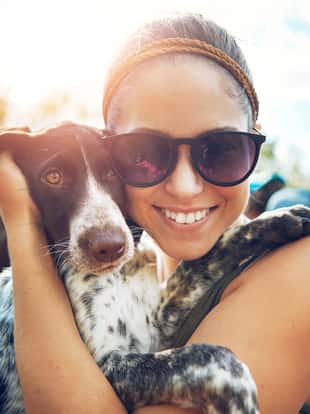 Shot of a young woman out camping with her dog