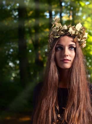 The young beautiful woman in dark forest