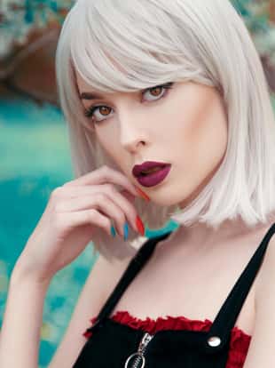 Young woman with bobbed hair close up portrait in nature