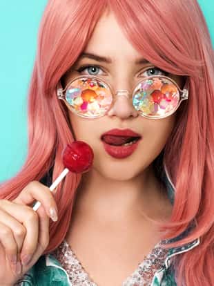 Young woman with kaleidoscope sunglasses holding lollipop
