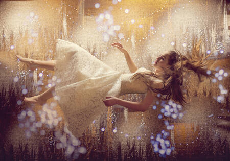 Girl floating in lights and stars.