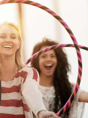 Friends playing with hula hoop