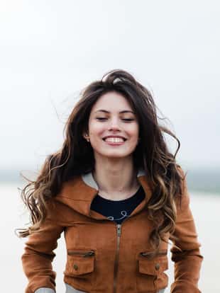Beautiful outdoors portrait of a woman in leather coat