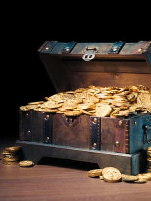 Open treasure chest filled with gold coins / HIgh contrast image