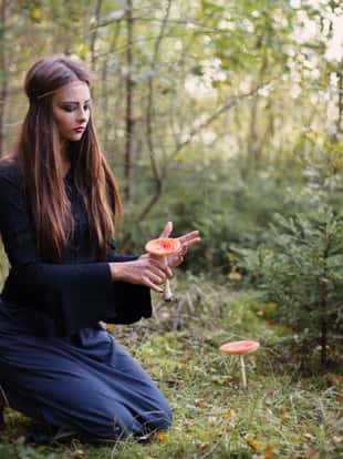 beautiful witch holding a mushroom