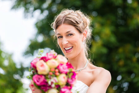Wedding bride with bridal bouquet outside at garden